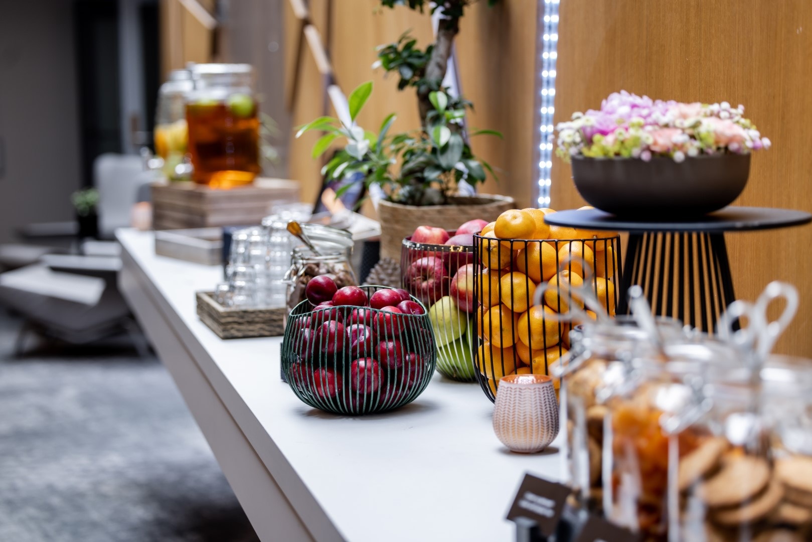 Fruit, drinks and flowers on a buffet counter