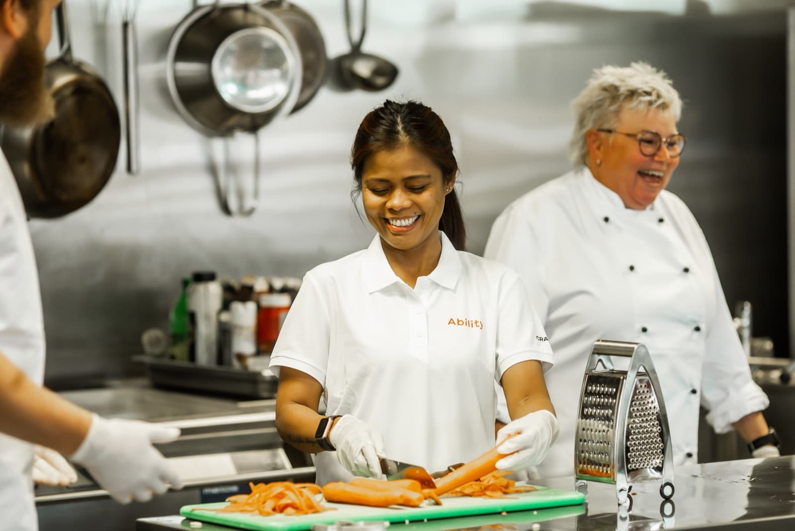 Ability service employee and chef working in a hotel kitchen